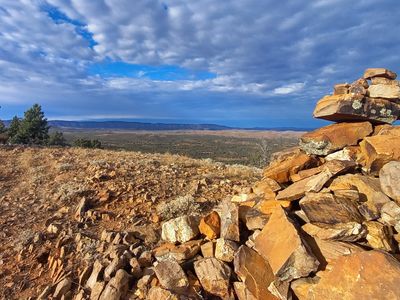flinders rangers, fluffy clouds, blue sky, rock pile and a view of a gully