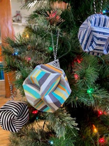 Colorful geometric fabric ornaments on a Christmas tree.