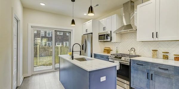 Modern kitchen with blue cabinets and island.