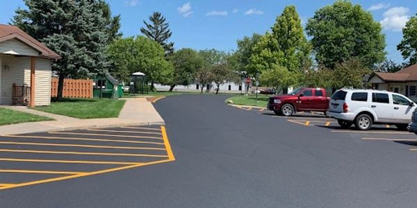 Commercial Asphalt Paving & Sealcoating parking lot in Rochester, NY by College Bound Sealers.