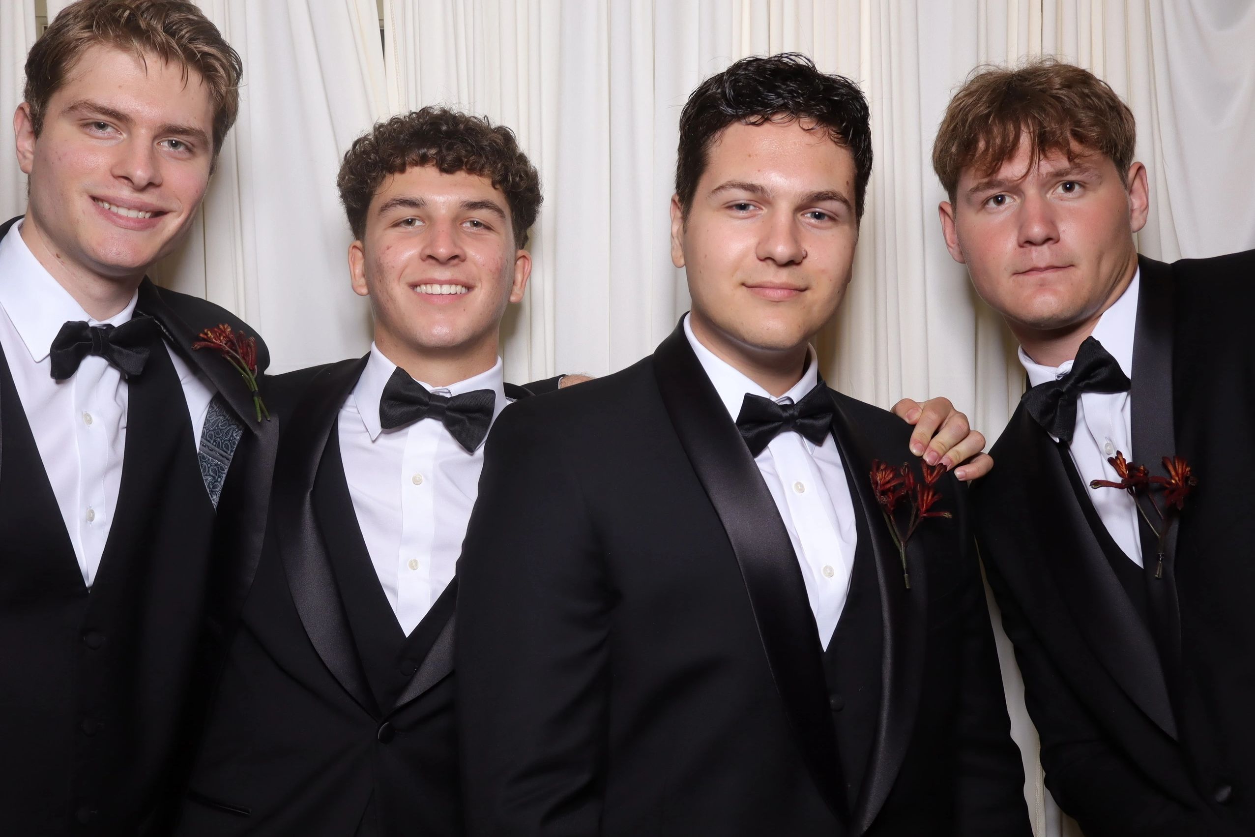 Groomsmen at a wedding taking a picture at a photobooth