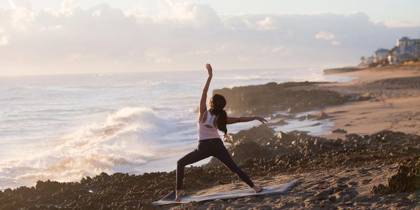 Image of a woman dancing on the beach. Photo by Amanda Smith Photography.