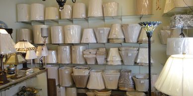 A variety of lampshades displayed on shelves.