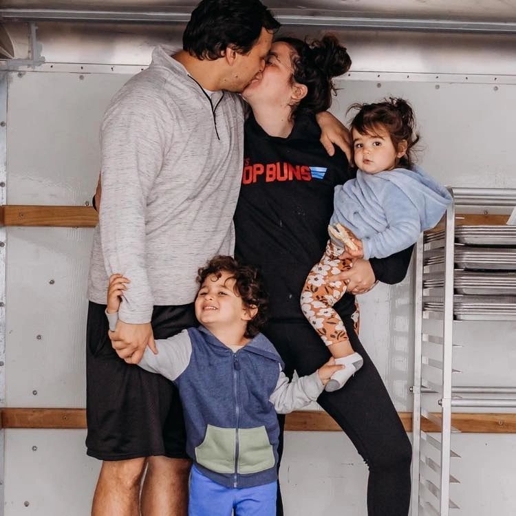 A loving family standing in a U-Haul holding one another