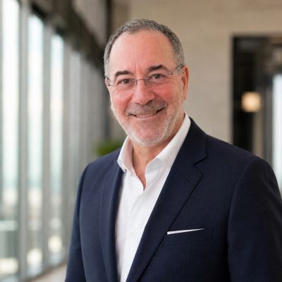 Smiling elderly man in business attire.
