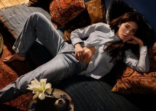 Gracie Abrams lying on cushions from a  birds eye view