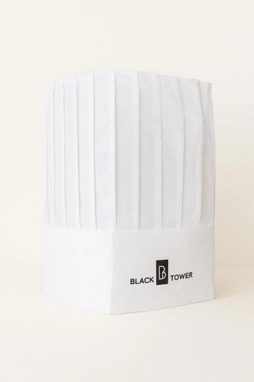 A white chef's hat with Black Tower logo on a plain background.