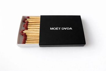 A box of matches with 'MOËT DYDA' written on the cover.