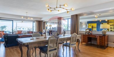 Elegant dining area with vintage chairs and a modern chandelier.