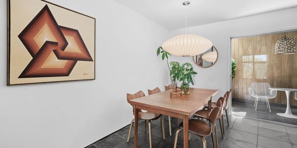 Dining Room featuring George Nelson Bubble Lamp, a set of Arne Jacobsen chairs and vintage artwork.