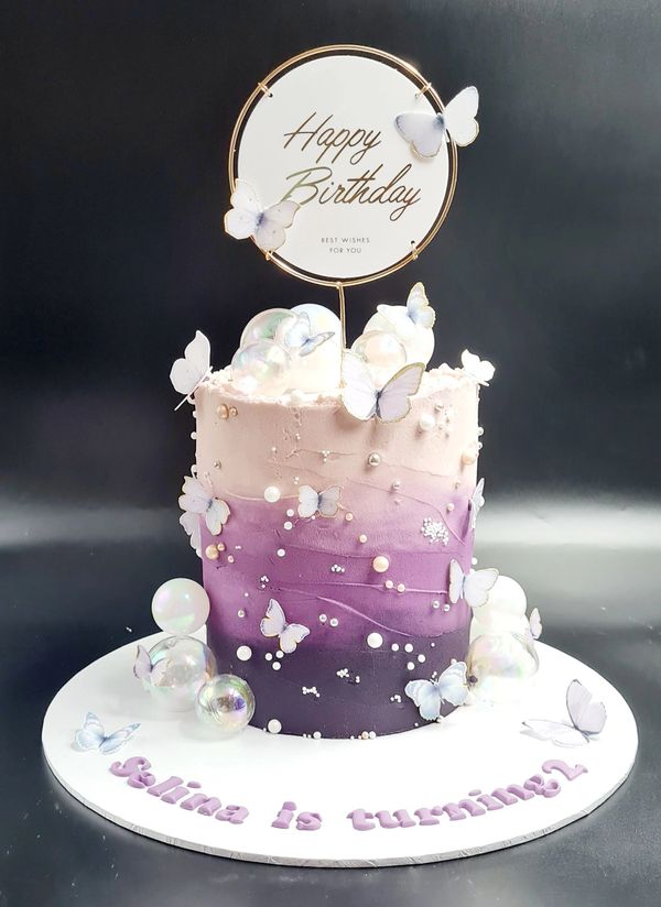 purple lilac ombre wave cake with pearls and butterflies and irredescent balls