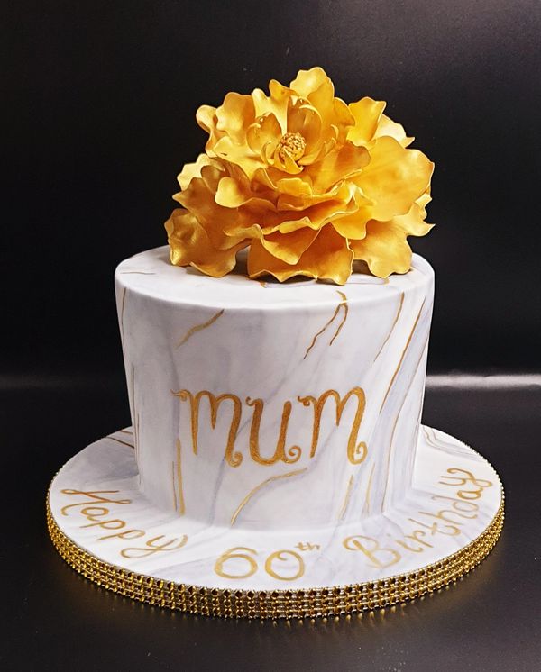 grey marbled cake with yellow peony 