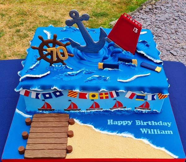 nautical themed sea cake with ships wheel and and buoy