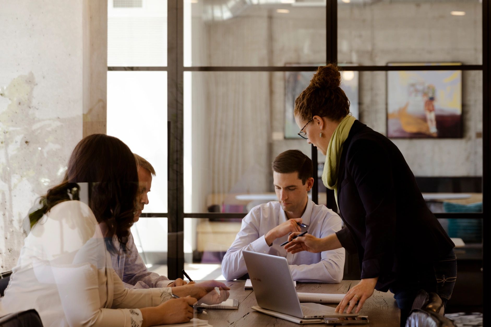 Engage's four partners working at a conference table.