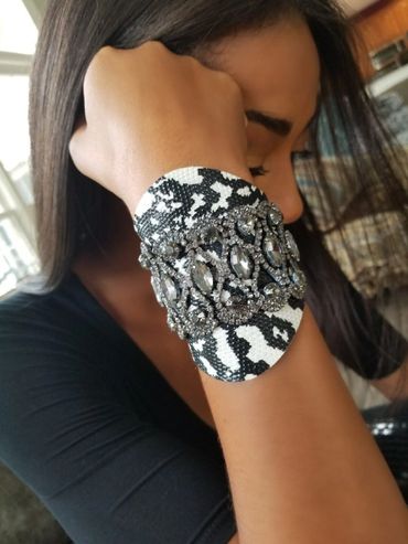 Animal print wide leather cuff with crystals and snap closure