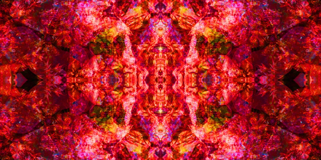 Vibrant symmetrical abstract art with intense red and multicolored textures.