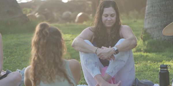 Woman meditating outdoors with eyes closed.