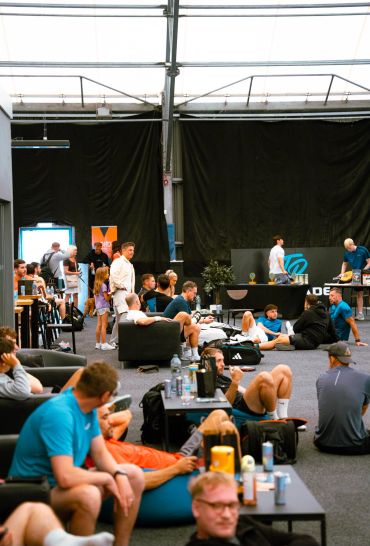 People relaxing and socializing indoors in a large room.