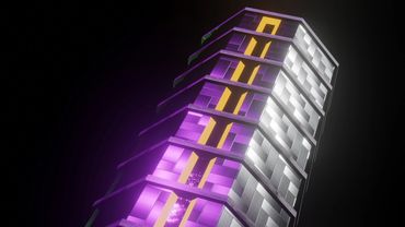 A futuristic building with purple and yellow illuminated sections against a dark sky.