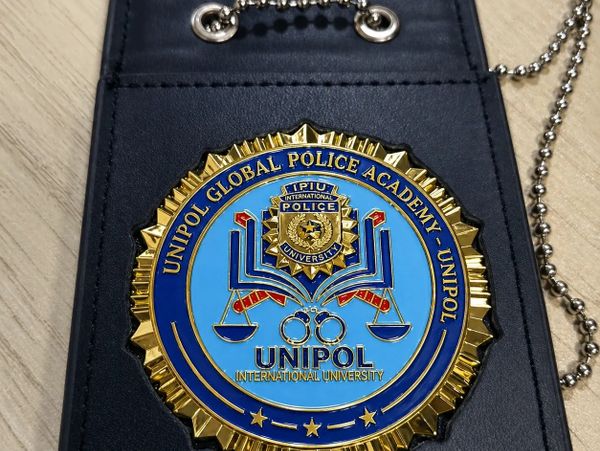 Badge of UNIPOL Global Police Academy with a blue and gold design.