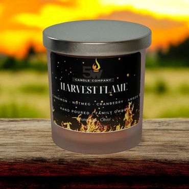 Experience the essence of autumn with our Harvest Flame 9 ounce candle. Blending warm cinnamon and n