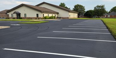 Empty parking lot beside buildings.