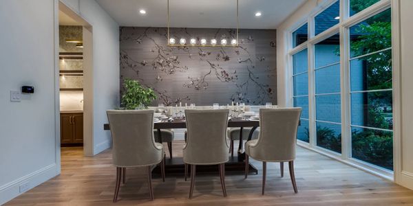 Modern dining room with elegant chairs and large windows.