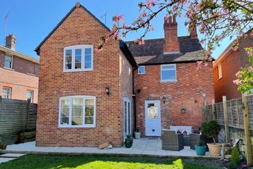 Red brick extension on 1900's detached red brick house