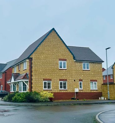 Beckstone and red brick detached house