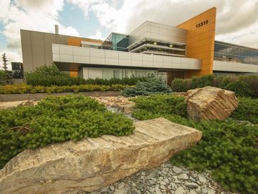 Modern building with landscaped rock garden in front.