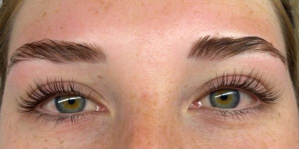Close-up of eyes with long lashes and shaped eyebrows.