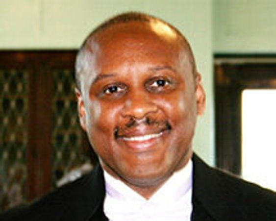 Smiling man in formal attire.