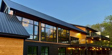 Modern rustic barn with glass walls and panoramic viewa at a Catskills wedding and event venue.
