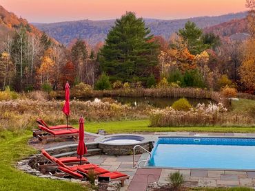 Heated pool and hot tub with autumn mountain views at a Catskills wedding venue near Callicoon, NY