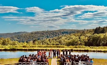 Outdoor lakeside wedding ceremony with mountain views in the Catskills