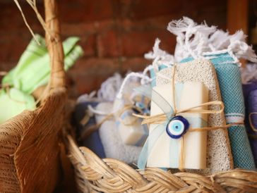 The image shows a close-up of a woven basket filled with various handcrafted or artisanal bath