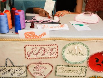 
The image depicts a craft stall or workshop, likely at an outdoor market or fair