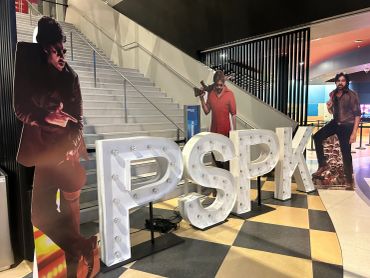 Cardboard cutouts and PSK letters displayed indoors.