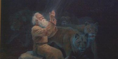 An elderly man peacefully praying surrounded by three lions in a dark setting.