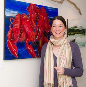 Nicole standing in front of her large and bright lobster painting at one of her gallery openings.