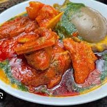 A colorful plate of Nigerian traditional soup with meat and egg.