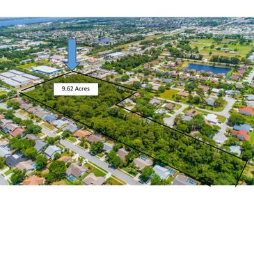 Aerial view of a 9.62-acre wooded land plot outlined in black within a suburban neighborhood.