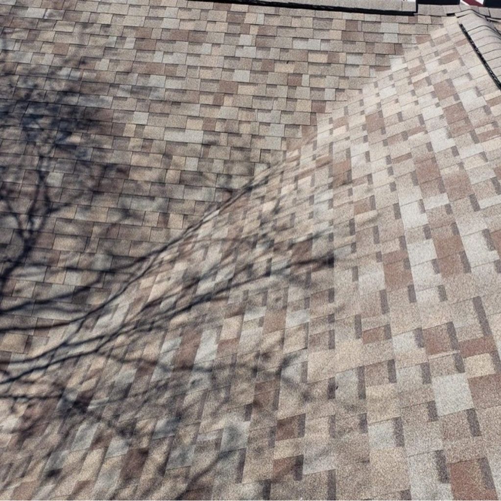 Photo of a roof valley covered by architect asphalt shingles.