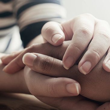 Therapist holding clients hand.