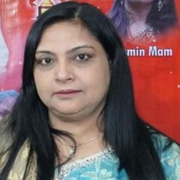 Woman with long black hair in a blue traditional outfit.