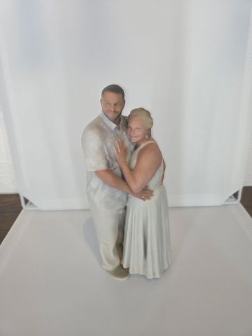 A 3D statue of a loving couple.