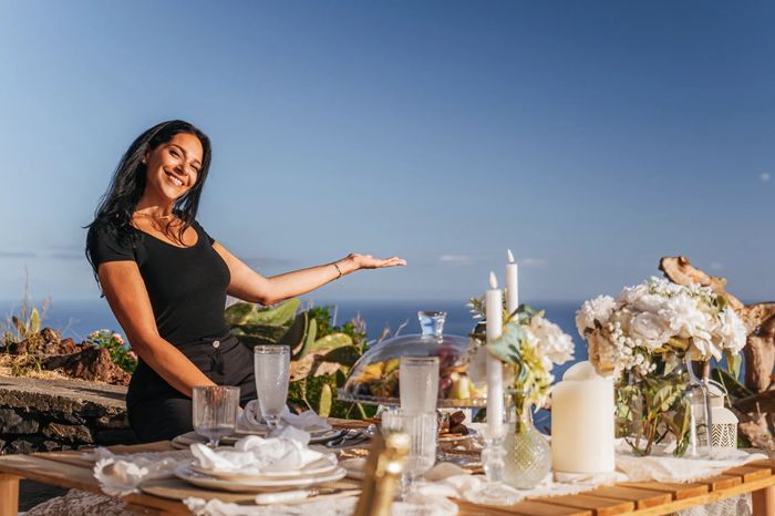 Berry, founder of making memories madeira, smiling, showing luxury picnic on a cliff with ocean view