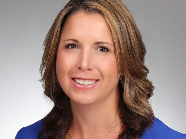 Professional portrait of a woman with blonde highlights.