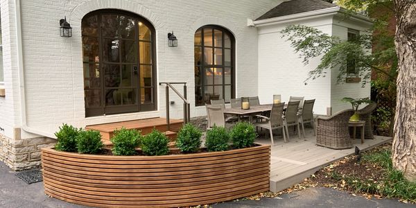 A beautiful deck with a custom flower box and combination of Ipe Walnut & TimberTech decking