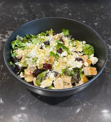 Fresh mixed greens salad with grilled chicken and feta cheese.
